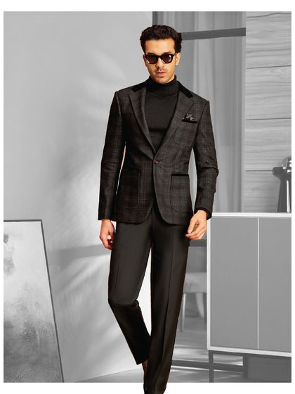 Designed for the man who values quality and style. This dark plaid suit with a velvet collar, paired with a black turtleneck, is a look that is both modern and timeless.