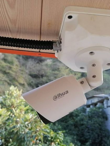 This Dahua camera is installed under an eave, providing a clear view of the property's perimeter while being sheltered from direct rain. Proper placement is key to effective surveillance.