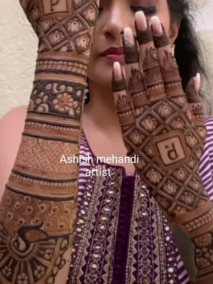 A bride showing off her modern initial mehandi, which combines geometric patterns with traditional peacock motifs.