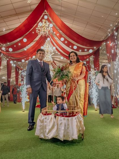 A grand entrance for the birthday boy at his 'Cirque Royale' party. The dramatic red draping and sparkling pyrotechnics create a truly majestic moment, making the family feel like the stars of the show.