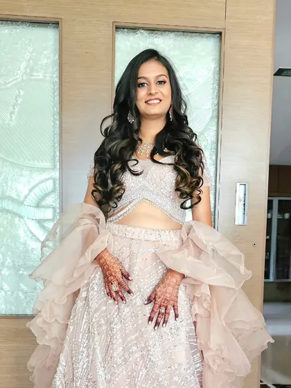 The complete engagement look for Preksha. Her soft, bouncy curls and glowing makeup were a perfect match for her elegant pastel lehenga.