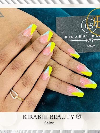 A vibrant and geometric design perfect for summer. I used neon yellow and pastel blue to create this sharp, color-blocked look on long coffin-shaped nails.