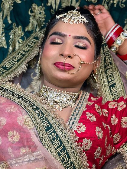A close-up of Nisha's bridal look with her eyes closed, showing the beautiful gold and pink shimmer on her eyelids.