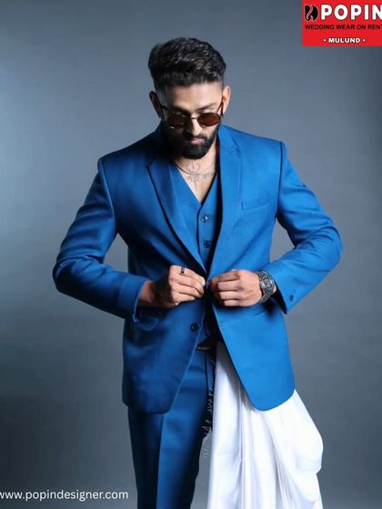 A model showcasing the vibrant blue three-piece suit. The clean lines and sharp tailoring make it a go-to for anyone wanting a contemporary formal look.