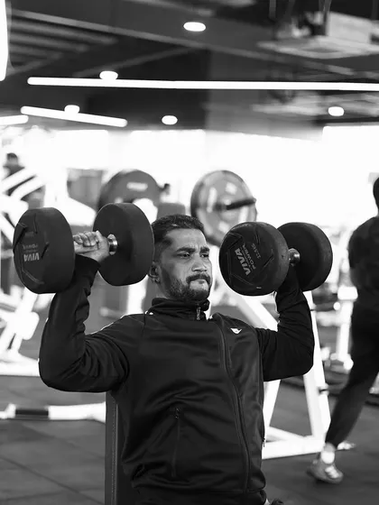 The seated dumbbell shoulder press is a fundamental exercise for building powerful and broad shoulders. Focus and form are everything.