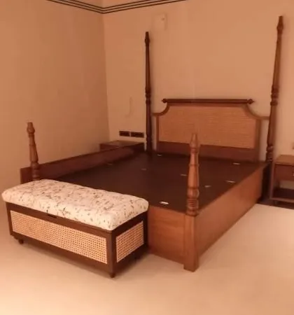 A beautiful four-poster bed made from teak wood with a cane-woven headboard. I also built the matching storage bench at the foot of the bed, which features cane detailing to tie the whole set together.