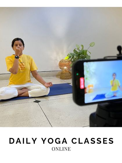 Our daily online classes are a cornerstone of our offerings. Here, a teacher demonstrates a pranayama technique, which is streamed live to students around the world, fostering a sense of global community.