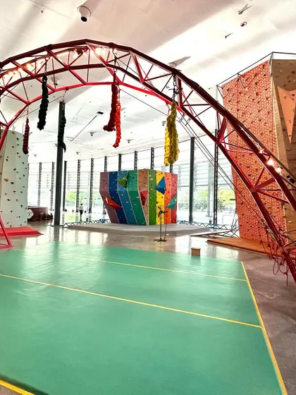 Take a look at our diverse climbing setup. From the tall brick top-rope wall to the multi-colored bouldering structure and the unique red arch, we have something to challenge and excite every climber who walks through our doors.