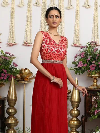 This angle captures the beautiful flow of the pleated skirt and the vibrant hue of the red dress.