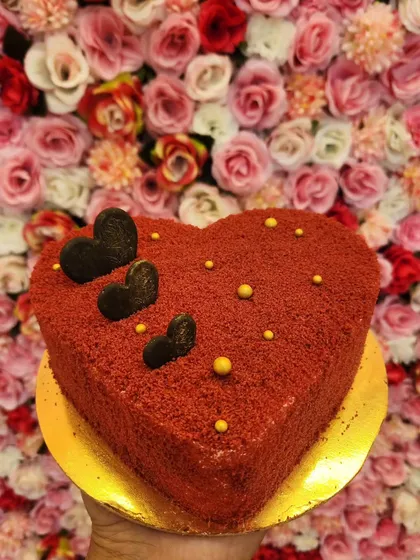 My Red Velvet cake in a heart shape, perfect for anniversaries or Valentine's Day. The rich red crumb coating and dark chocolate hearts make it a simple yet beautiful way to show your love.