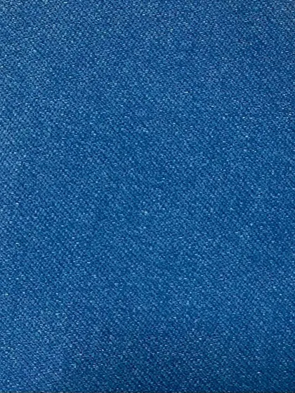 The texture of a bright blue denim. This non-stretch fabric has a classic, sturdy feel and a brilliant color that holds up well over time.