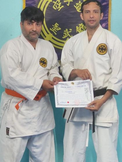 An adult student receives his 7th Kyu (orange belt). I commend his dedication to learning authentic Okinawan karate.