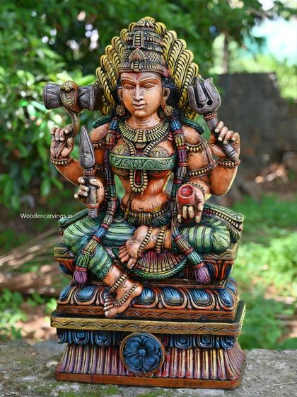 A 30-inch sculpture of Goddess Shri Devi (Amman) holding her divine weapons, the Tirishul (trident) and Udukkai (drum). The antique, multi-colored finish gives her a powerful and ancient presence.