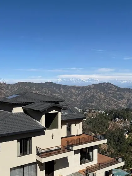 Another view of 'Soulitude,' showcasing its relationship with the dramatic Himalayan landscape. The design aims to be a quiet observer, a built form ensconced in nature.