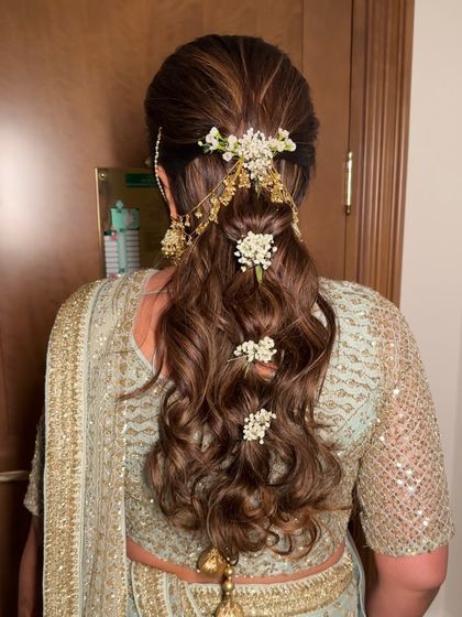 Braided waves adorned with baby's breath and dainty jewels. This hairstyle for a pastel-themed wedding was soft, romantic, and utterly striking.