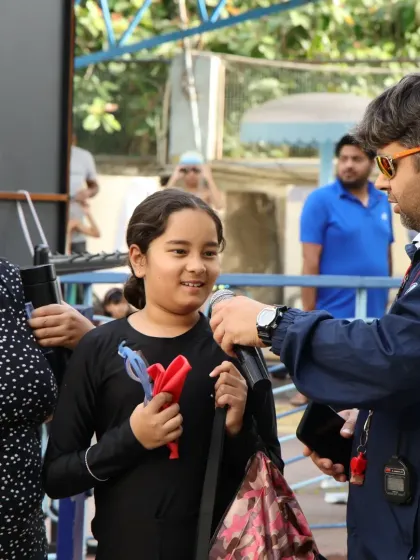Interacting with a young swimmer and her mother. It is important for me to connect with the families and make sure everyone feels welcome.
