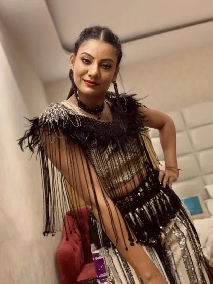 Getting ready backstage for a New Year's Eve performance. This costume, with its intricate fringe and sequin details, was designed for maximum movement and visual flair on stage.