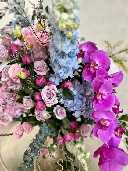 A close-up of my vintage romance-inspired arrangement. The details of the Kenyan Delphinium, Dutch Phalaenopsis, and lilac roses show the quality and beauty of the imported blooms I use.