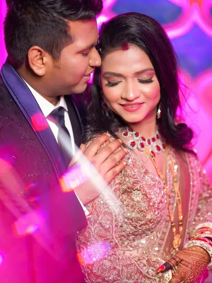 A close-up, intimate moment. The soft lighting and glamorous makeup create a truly romantic and beautiful image.