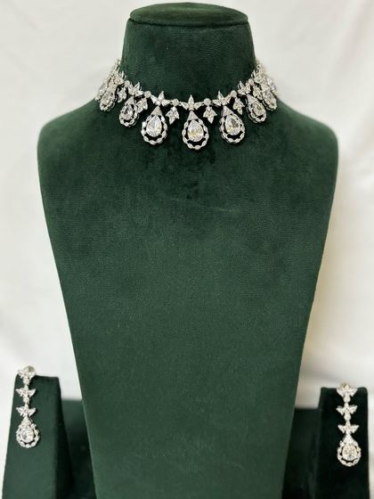 A full view of a simple American diamond necklace and earring set. This is an elegant and understated rental choice.