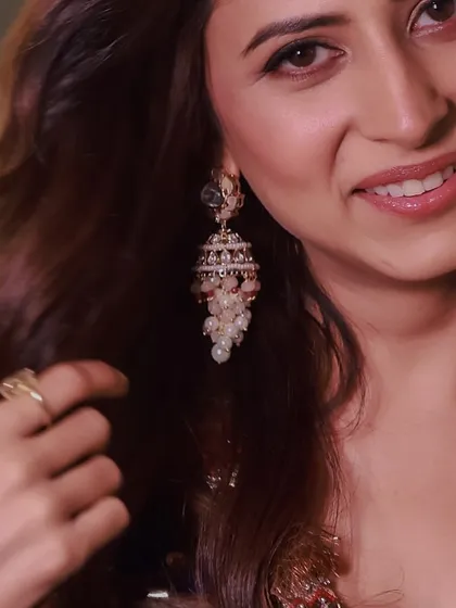 A close-up of actress Sargun Mehta, wearing our delicate pearl cluster jhumkas for a promotional event.