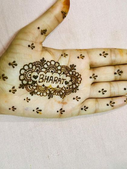 A simple and sweet design, with the name "Bharat" and a heart at the center of the palm. This is a lovely idea for an engagement or for Karva Chauth.