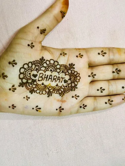 A simple yet meaningful design. The name 'Bharat' is written inside a heart-shaped mandala, surrounded by delicate dots, making it a sweet and personal statement.