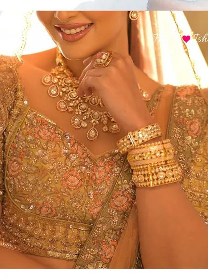 A detailed shot of the bride's hands, adorned with stacked Polki bangles and a statement ring, showing how to accessorize the full bridal look.