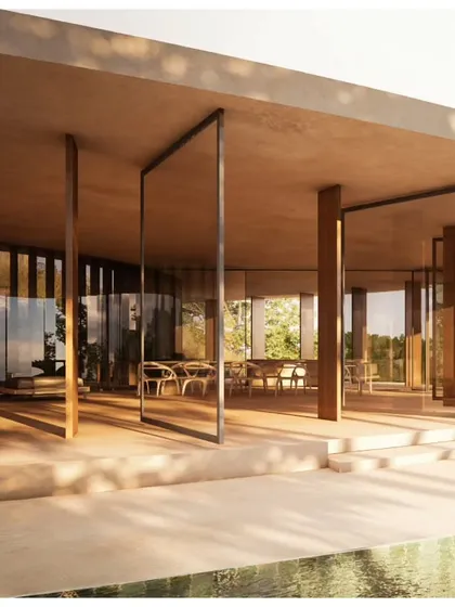The interior of Amar Villa features floor-to-ceiling glass and pivoting doors, blurring the boundary between the indoor dining area and the outdoor pool deck.