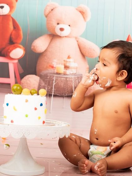 A full-on taste test. This baby is digging into his cake with both hands, and his expression is priceless. These are the fun, candid moments that make the best memories.