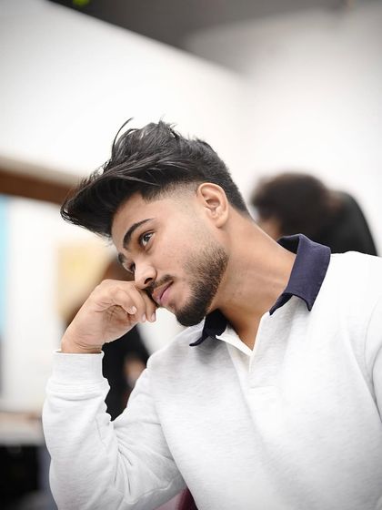 This young client's first taper fade, and he looks amazing. It's a modern, edgy style that's very popular.