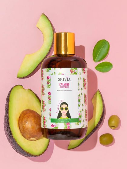 A vibrant flatlay that tells an ingredient story. We surrounded the calming body wash with slices of fresh avocado and olives, visually communicating its natural, nourishing formula against a contrasting pink background.