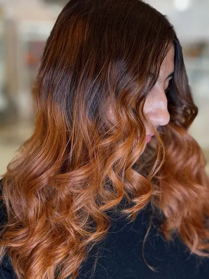 A beautiful warm-toned ombre with shades of copper and auburn. The soft waves enhance the richness of the colors.