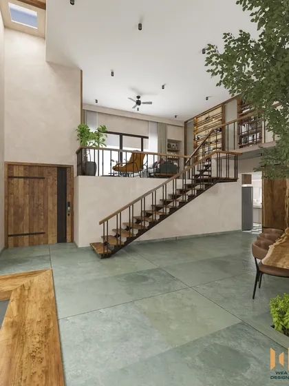 A view from the ground floor looking up at the mezzanine and staircase, showcasing the home's vertical space and natural materials.