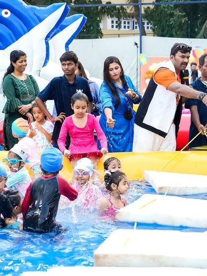 An entertainer guiding kids through a water obstacle course. I plan interactive games that are both fun and challenging for the children.