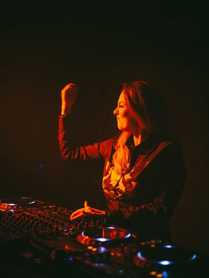 A candid shot of me feeling the music during a set. These are the moments of pure joy that I share with the audience.