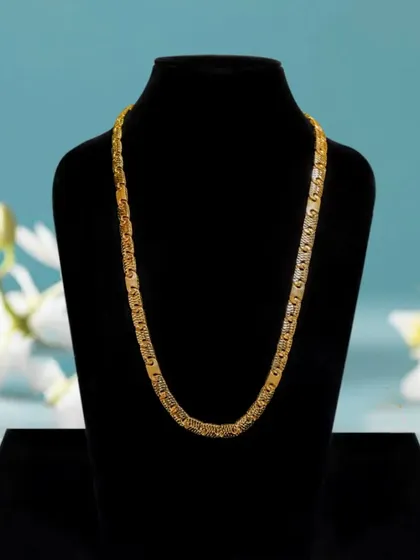 For jewelry catalogs, I shoot pieces on a classic black bust. This ensures customers see the exact shape, size, and detail of the product, like this elegant gold chain, helping them make a confident purchase.