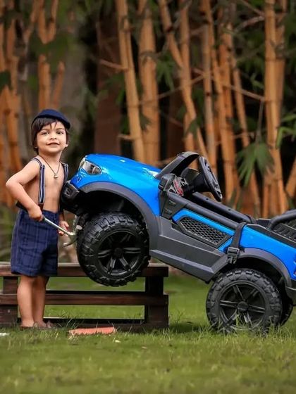 This little mechanic is hard at work, pretending to fix his jeep in our outdoor garage setup. It's a great theme for imaginative play.