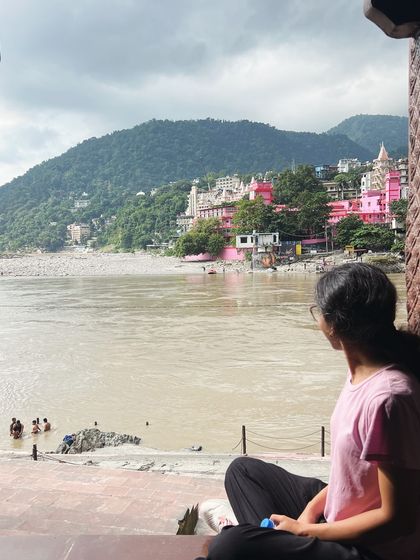 Looking out at the Ganges, a participant finds a moment of solitude and reflection. The river is a powerful symbol of life's constant flow.
