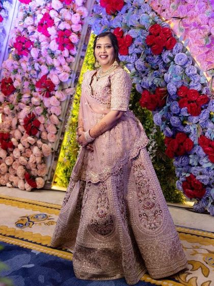A full-length shot of the sister of the groom in her beautiful pink lehenga. The makeup is subtle yet defining.