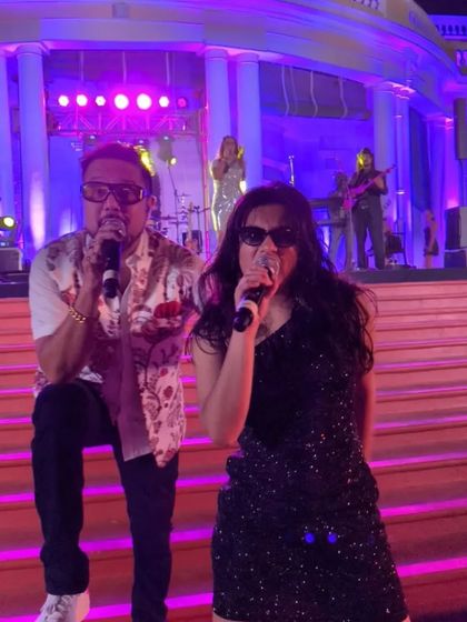 A close-up of me and my mentor performing together at the Madras Club. This shot shows our strong connection and the dynamic energy we bring as front-persons for the band.