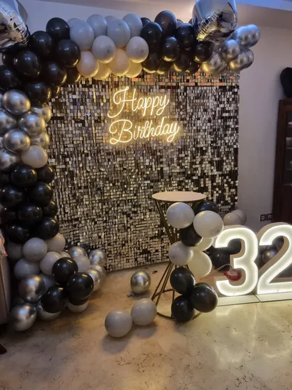 A clear, centered shot of the 32nd birthday sequin wall backdrop.