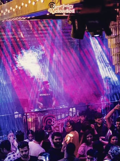 A vibrant shot from a throwback special at Sugar Factory Reloaded. The mix of blue and pink lights with my visuals on the screen creates a dynamic atmosphere that gets everyone moving.