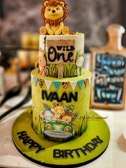 A party shot of the "Wild One" cake for Ivaan, showing how it perfectly complements a jungle-themed first birthday celebration.