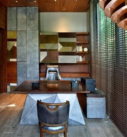 The study at T House is a masterpiece of custom design. A leather and suede back unit, a rosewood desk with a faceted base, and copper pendant lights create a space of powerful beauty.