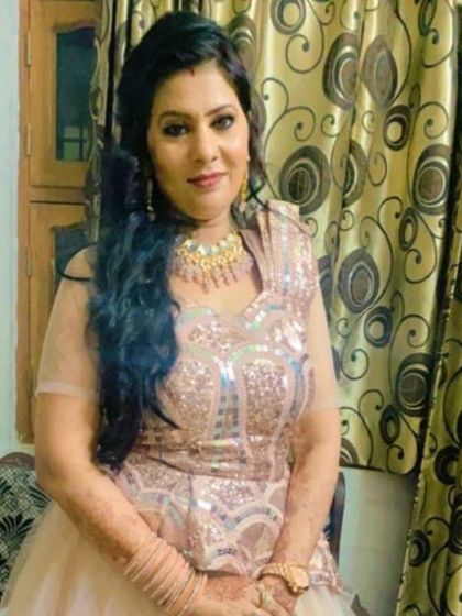 A happy client in a rose-gold sequined gown, perfect for an engagement or reception party.