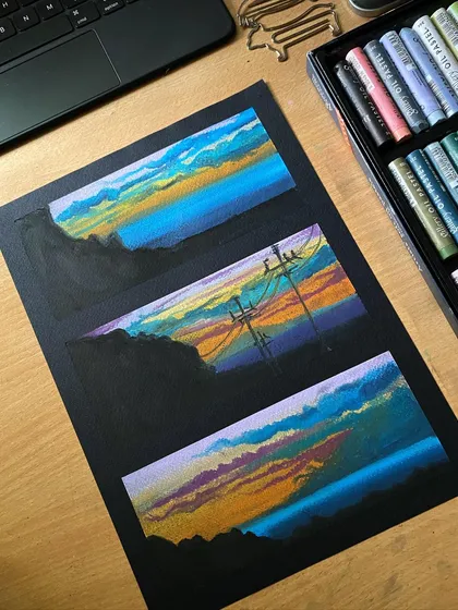 A series of three mini landscape paintings done with oil pastels on black paper. The dark background makes the colors of the sunset skies appear incredibly vibrant and dramatic.