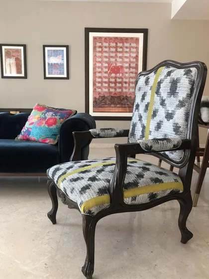 This view shows how my Pichwai paper works are displayed alongside a custom-upholstered accent chair. It demonstrates how you can mix different art forms and textures to create a rich, layered interior.