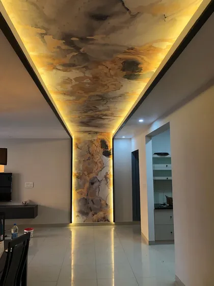 Another view of the illuminated ceiling and pillar, showcasing the flawless reflection on the glossy floor. The quality of the installation is clear in every detail.
