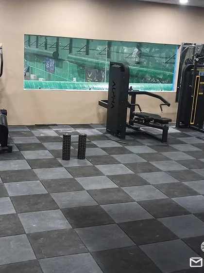 The gym is equipped with durable, shock-absorbent flooring and a wide array of equipment to support diverse workout routines, from general fitness to sport-specific strength and conditioning programs.